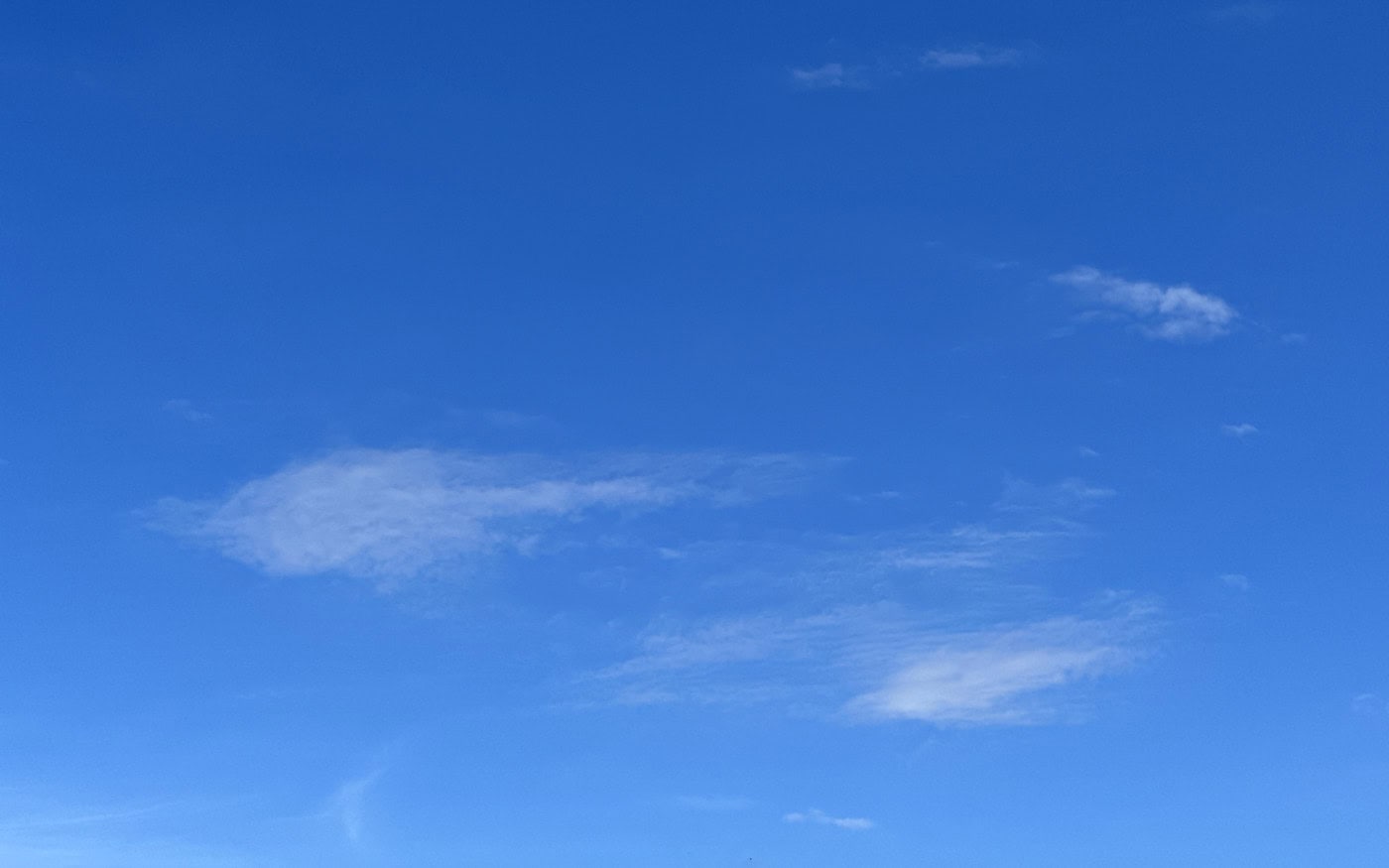 a small patch of very thin, high, cirrocumulus clouds against a blue sky